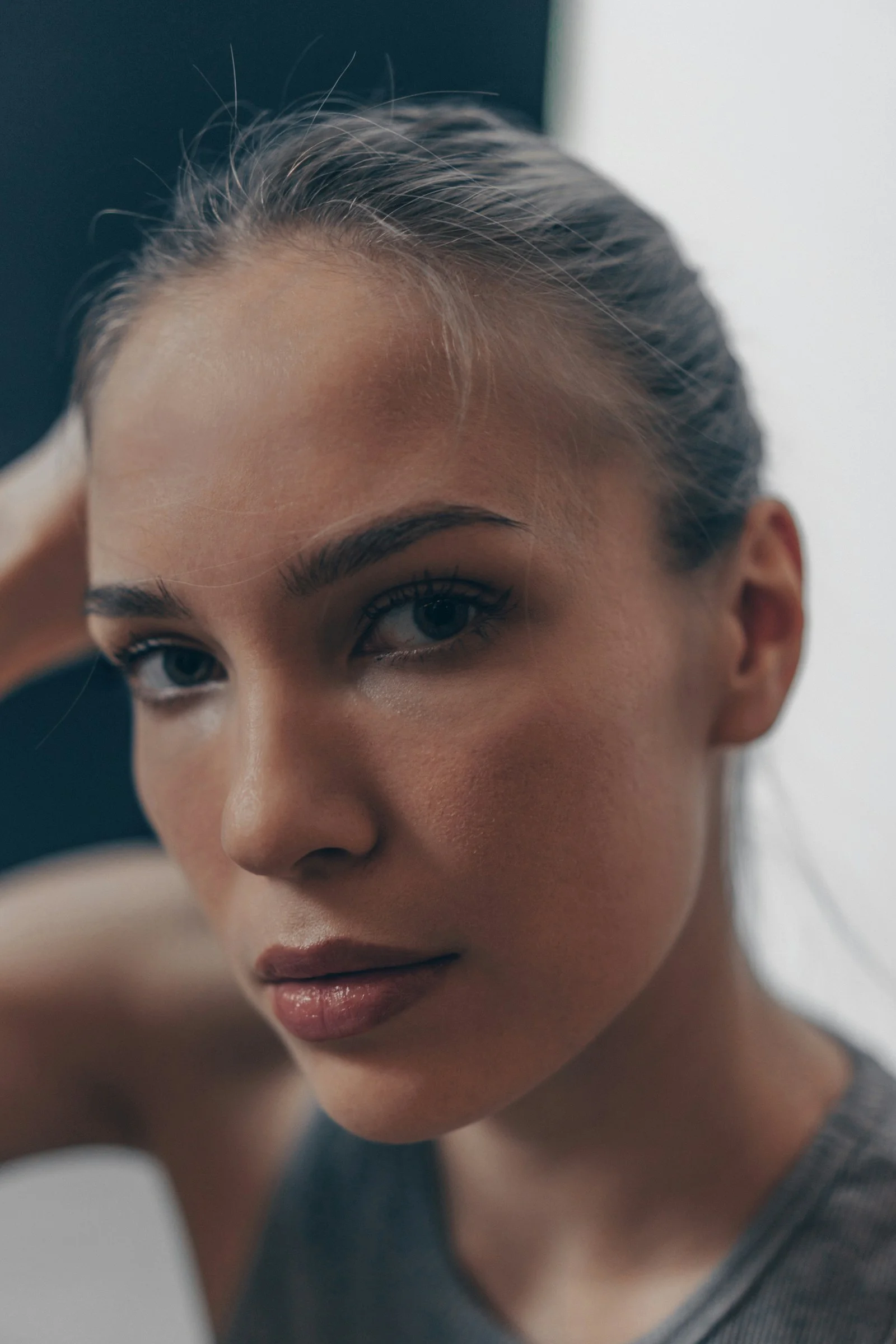 A young woman with dark hair looks directly forward