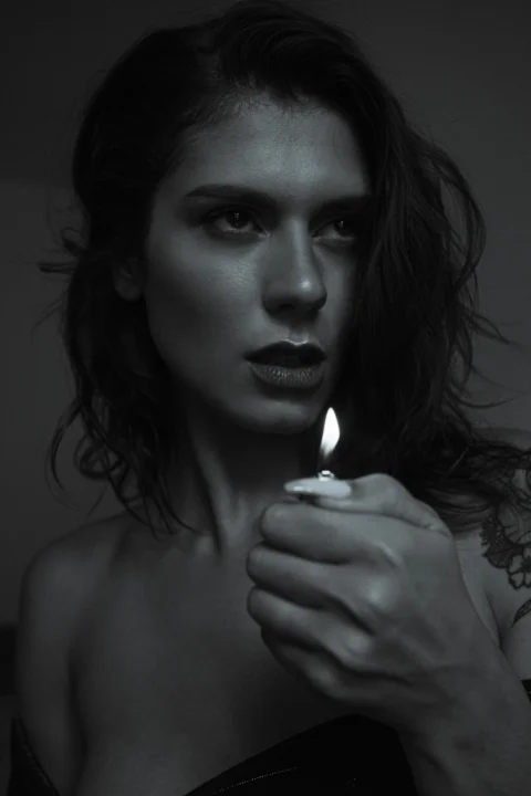 a woman holding a lit candle in her hand