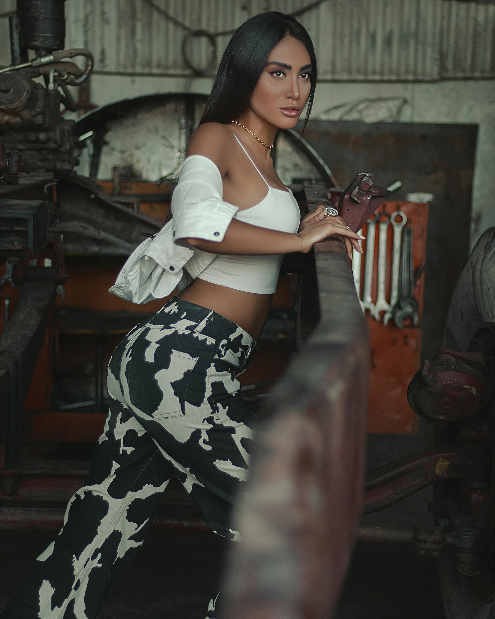 a woman in a white top and black and white pants