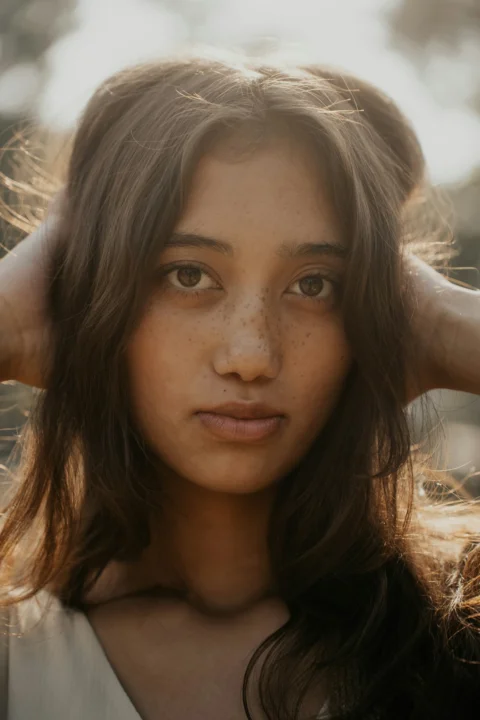 A young girl is posing for a picture