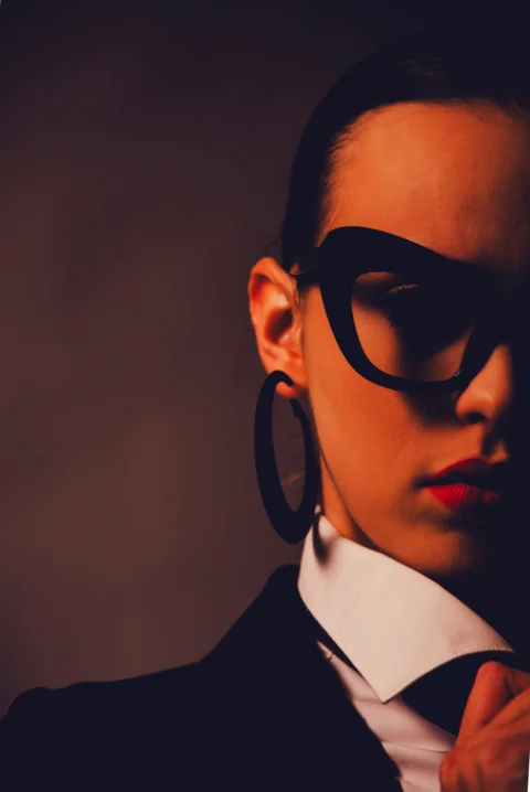 Woman with glasses and hoop earrings