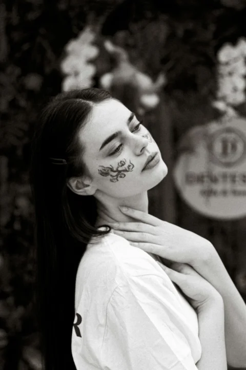 A woman with her face painted with flowers