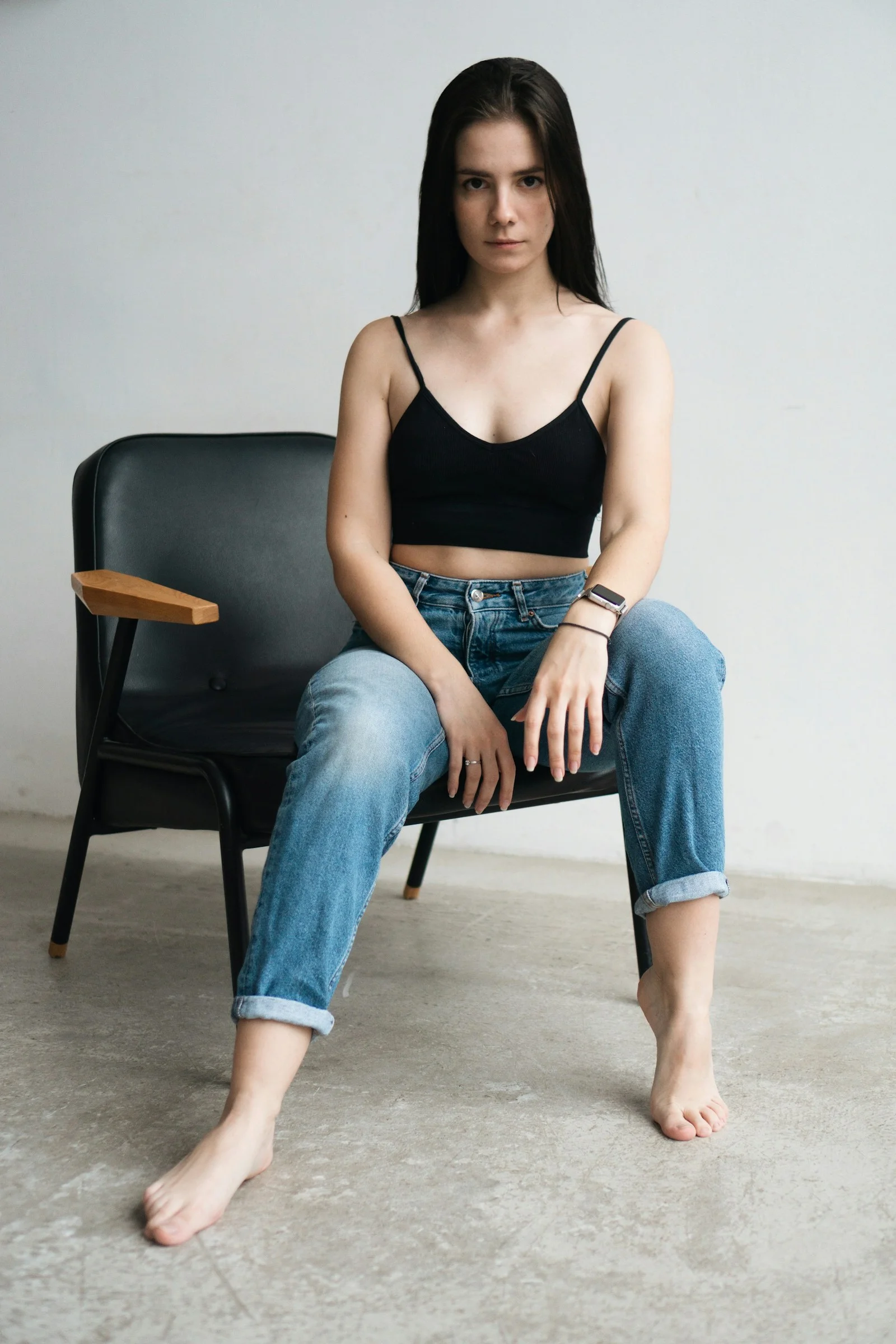 a woman sitting on a chair with her legs crossed