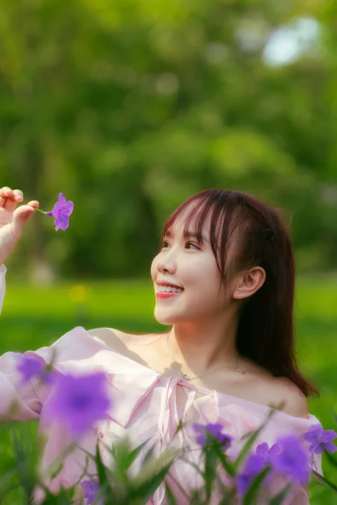 A woman sitting in a field of purple flowers