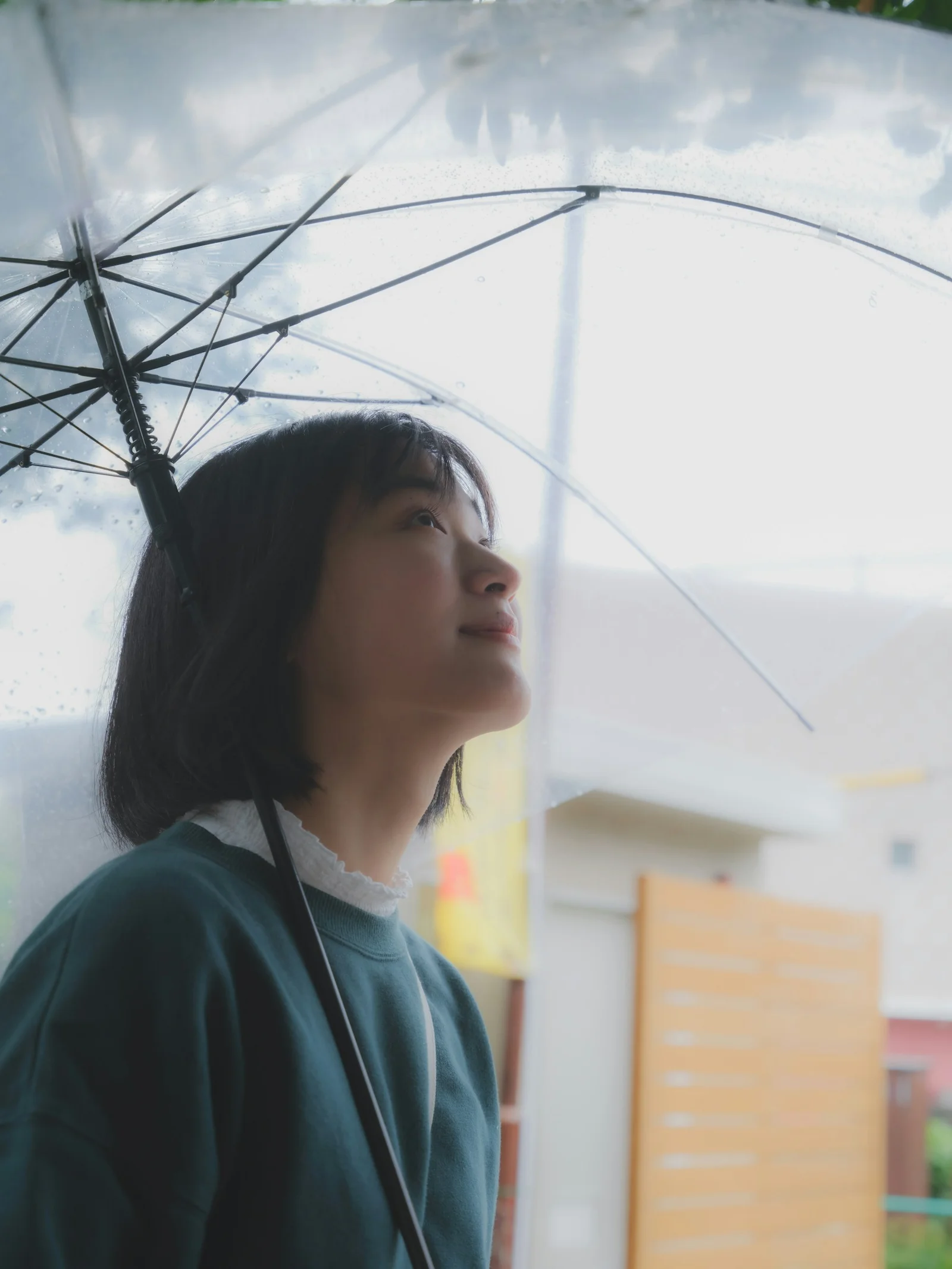 a woman standing under an umbrella in the rain