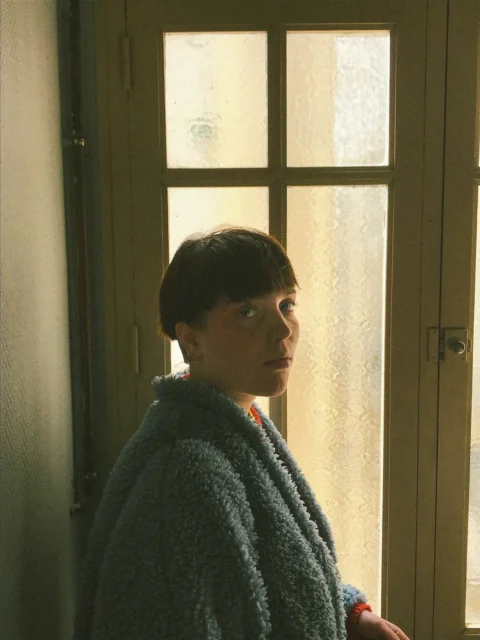 woman standing beside closed door
