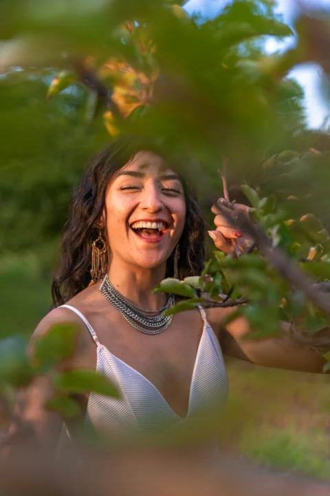 a woman in a white dress is smiling