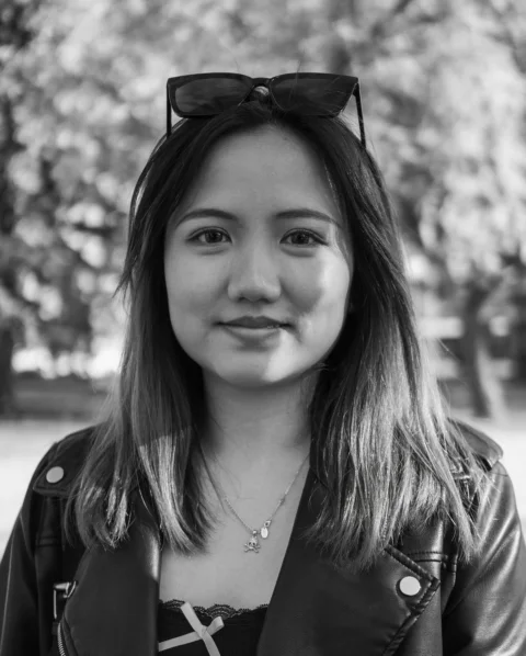 A young woman poses for a black and white photo